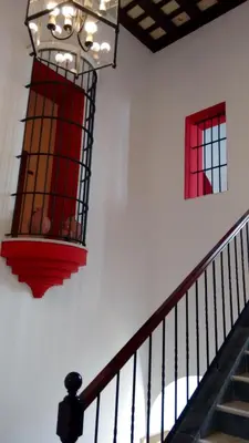 a staircase with a red window and a stair case at Casa del Regidor in El Puerto de Santa María