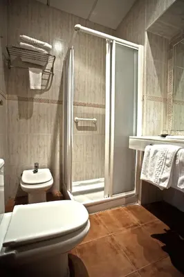 a bathroom with a toilet and a glass shower at Casa del Regidor in El Puerto de Santa María