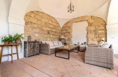 a living room with couches and a brick wall at Loft Bodega San Blas con porche y parking in Jerez de la Frontera
