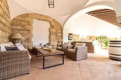 a living room with couches and a table at Loft Bodega San Blas con porche y parking in Jerez de la Frontera
