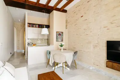 a kitchen and dining room with a table and chairs at innCádizPalacio Apolo in Cádiz