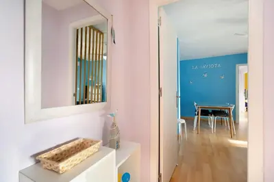 a hallway with a mirror and a dining room at La Gaviota in Rota