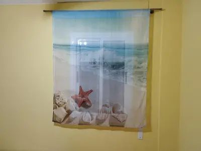 a curtain with shells and a starfish on a beach at La Gaviota in Rota