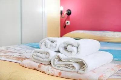 a pile of towels sitting on top of a bed at La Gaviota in Rota