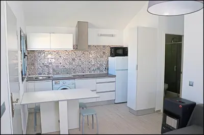 a kitchen with white cabinets and a white counter top at Chalet los Morenos in Conil de la Frontera