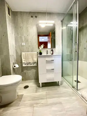 a bathroom with a toilet sink and a shower at GATU Villa Sol, junto a la playa , piscina, 2 baños, aire cc, terraza, 