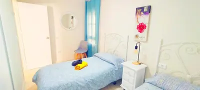 a bedroom with a bed with a yellow toy on it at Apartamento Tres Carabelas II, AC, Wifi, Parking in Sanlúcar de Barrameda