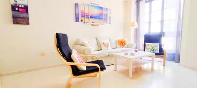 a living room with a couch and a table at Apartamento Tres Carabelas II, AC, Wifi, Parking in Sanlúcar de Barrameda
