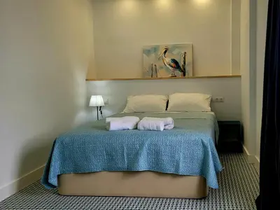 a bedroom with a bed with two towels on it at Casa Tina in Cádiz