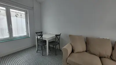 a living room with a couch and a table and chairs at Casa Tina in Cádiz