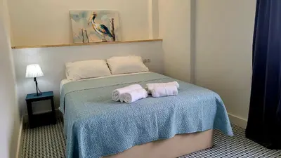 two towels sitting on a bed in a room at Casa Tina in Cádiz