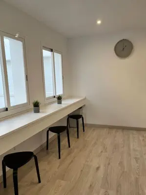 a room with a table and two chairs and a clock at Ático centro in El Puerto de Santa María
