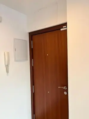 a wooden door in a room next to a wall at Ático centro in El Puerto de Santa María
