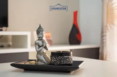 a small figurine sitting on a plate on a table at Apartamento la Infanta in Sanlúcar de Barrameda