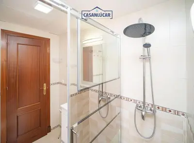 a shower with a glass door in a bathroom at Apartamento la Infanta in Sanlúcar de Barrameda