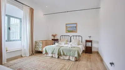 a white bedroom with a bed and a window at Casa Rural Viña Romanito Jerez de la Frontera by Ruralidays in Jerez de la Frontera