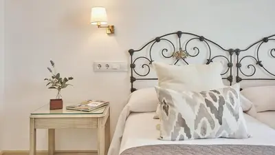 a bedroom with a bed and a table with a pillow at Casa Rural Viña Romanito Jerez de la Frontera by Ruralidays in Jerez de la Frontera
