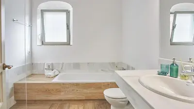a bathroom with a tub and a toilet and a sink at Casa Rural Viña Romanito Jerez de la Frontera by Ruralidays in Jerez de la Frontera