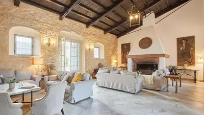 a living room with white furniture and a fireplace at Casa Rural Viña Romanito Jerez de la Frontera by Ruralidays in Jerez de la Frontera