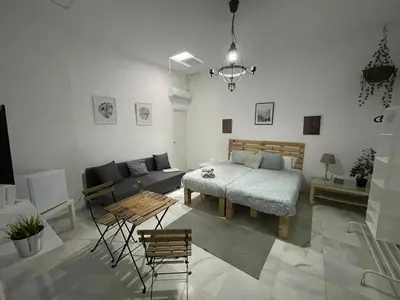a living room with a bed and a couch at BF BOUTIQUE JEREZ in Jerez de la Frontera