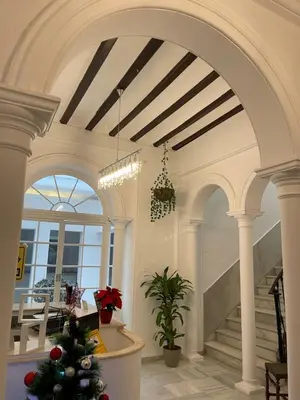 a room with a christmas tree in the middle of a building at BF BOUTIQUE JEREZ in Jerez de la Frontera