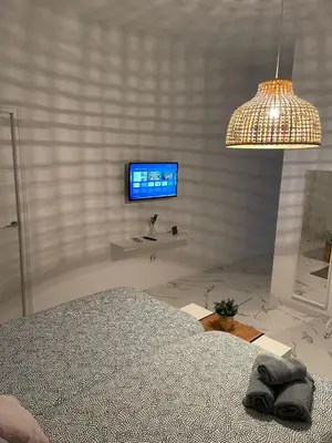a bedroom with a bed and a tv on a wall at BF BOUTIQUE JEREZ in Jerez de la Frontera