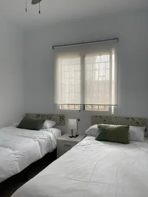 two beds sitting next to each other in a bedroom at Dúplex Céntrico perfecto para el disfrute in El Puerto de Santa María