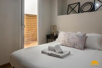 a white bed with towels on top of it at Writer's Home by Cadiz Time in Cádiz