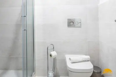 a bathroom with a toilet and a glass shower at Writer's Home by Cadiz Time in Cádiz