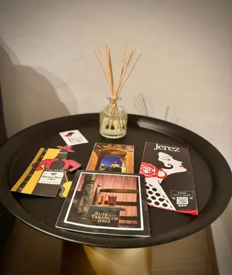 a black table with magazines and a vase on it at La Faraona in Jerez de la Frontera
