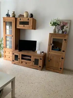 a living room with a tv and a wooden entertainment center at Apartamento Paola in El Puerto de Santa María