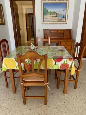a dining room table with a cat sitting on top of it at Apartamento Paola in El Puerto de Santa María