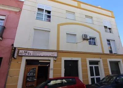 a building with a car parked in front of it at Apartamento Paola in El Puerto de Santa María