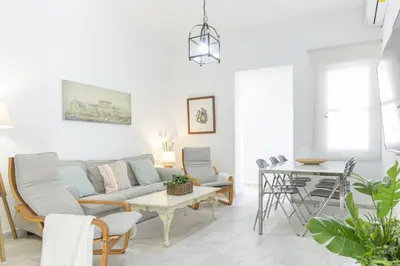a living room with a couch and chairs and a table at Playa de Regla, para un magnifico descanso. 3. in Chipiona