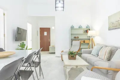 a living room with a couch and a table at Playa de Regla, para un magnifico descanso. 3. in Chipiona