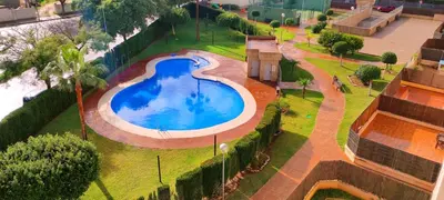 an overhead view of a swimming pool in a park at Apartamento TomCar Piscina, Pádel, wifi y zonas comunes in Sanlúcar de Barrameda