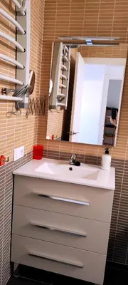 a bathroom with a white sink and a mirror at Apartamento TomCar Piscina, Pádel, wifi y zonas comunes in Sanlúcar de Barrameda