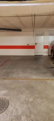 a garage with a car parked in a parking lot at Apartamento TomCar Piscina, Pádel, wifi y zonas comunes in Sanlúcar de Barrameda