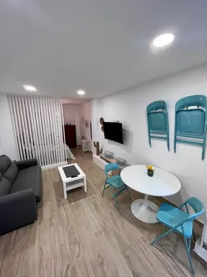 a living room with a couch and a table and chairs at GATU Villa Paraguay in Cádiz