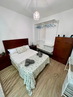 a bedroom with a bed with shoes on it at GATU Villa Paraguay in Cádiz