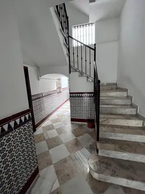 a staircase in a house with a checkered floor at GATU Villa Paraguay in Cádiz