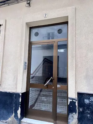 a door to a building with a staircase behind it at GATU Villa Paraguay in Cádiz