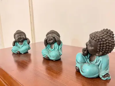 a group of three figurines sitting on a table at GATU Villa Paraguay in Cádiz