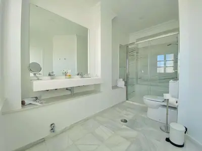 a white bathroom with a sink and a toilet at Hotel Boutique Las Cortes De Cádiz in Cádiz