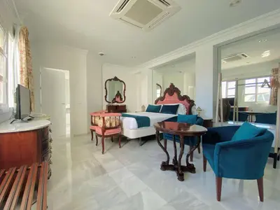 a bedroom with a bed and a table and chairs at Hotel Boutique Las Cortes De Cádiz in Cádiz