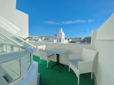 a table and chairs on a balcony with a view at Hotel Boutique Las Cortes De Cádiz in Cádiz