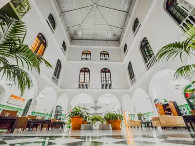 a bedroom with a large white bed and a couch at Senator Cádiz in Cádiz