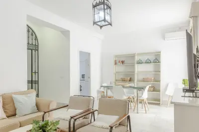 a living room with a couch and chairs and a table at Apartamento independiente en Playa de Regla. in Chipiona