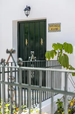 a green door on a building with a fence at Apartamento independiente en Playa de Regla. in Chipiona