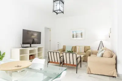 a living room with a couch and a table at Apartamento independiente en Playa de Regla. in Chipiona